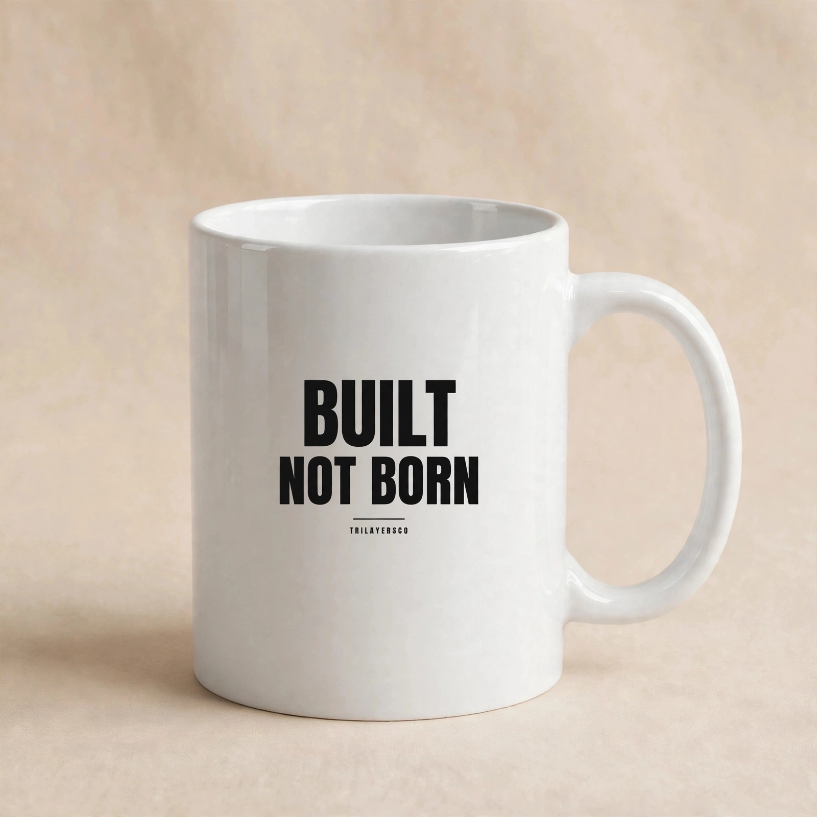Built Not Born mug in a warm, minimal workspace